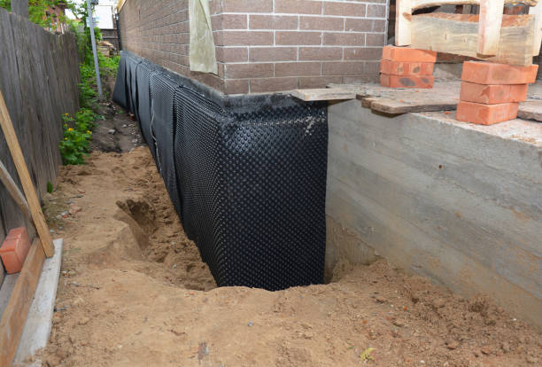 SJ Waterproofing Pros technician performing targeted Basement Waterproofing assessment in Crystal, MI